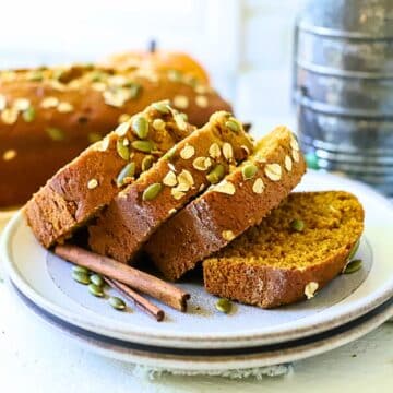 Pumpkin bread sliced on a plate.