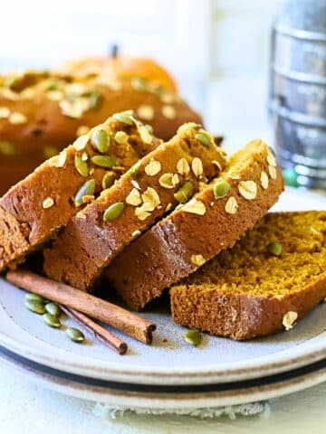 Pumpkin bread sliced on a plate.