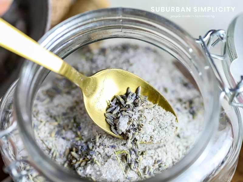 a spoon in a lavender bath salt jar