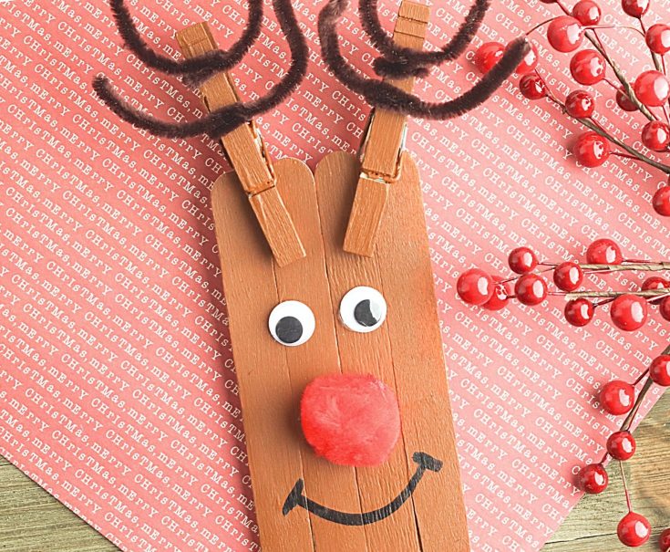 Reindeer Craft on a piece of Christmas paper