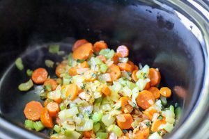 vegetables being added to crockpot