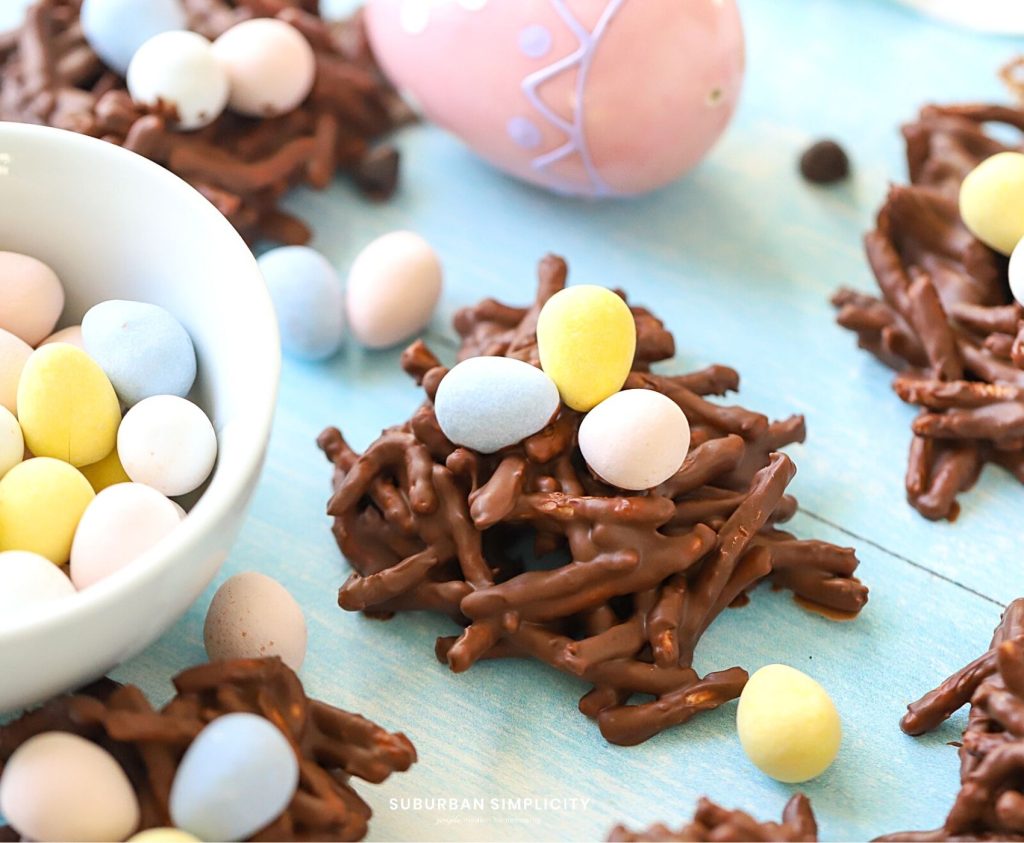 Bird nest cookies with candy next to it.