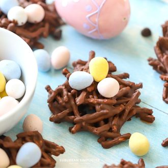 Bird nest cookies with candy next to it.