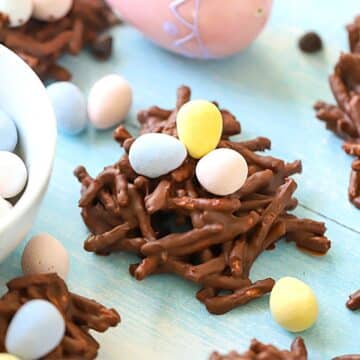 Chocolate bird nest cookies with colorful candies on top.