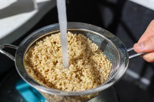 Brown Rice being rinsed