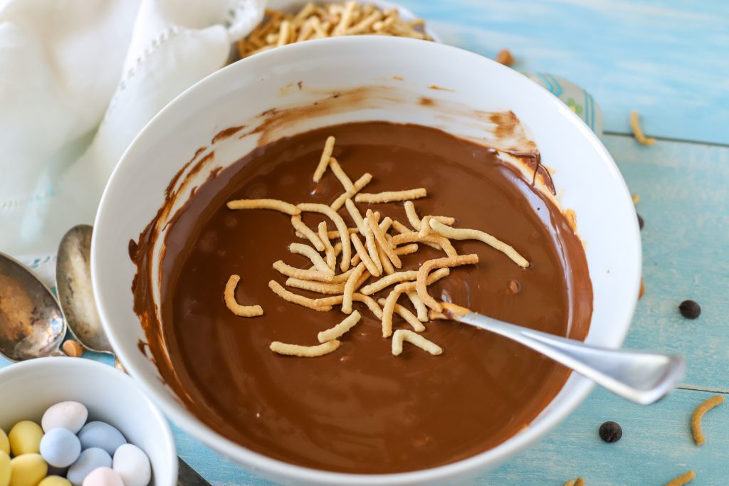 Chow mein noodles being added to chocolate