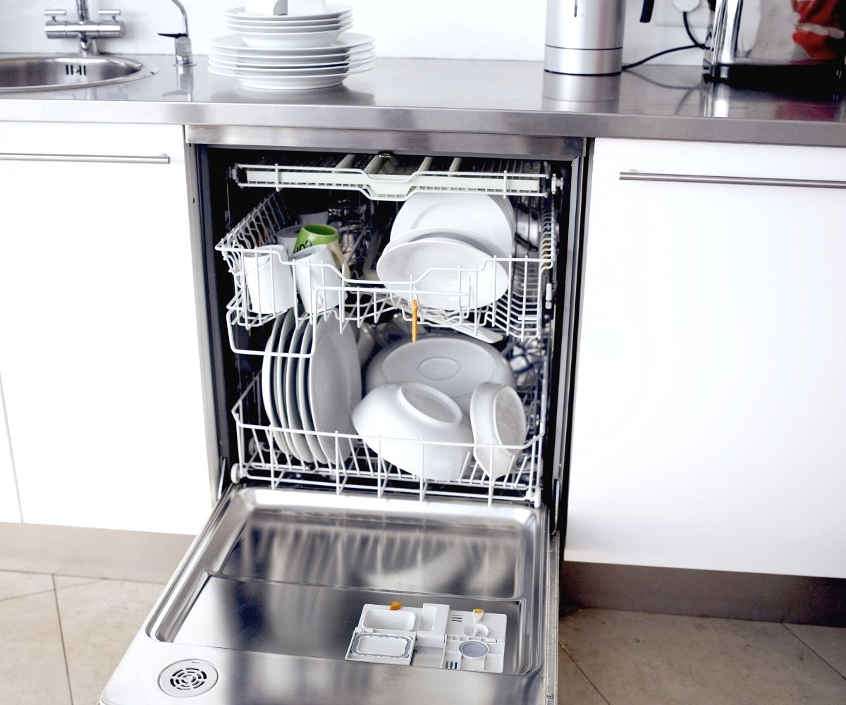 An open dishwasher with clean dishes