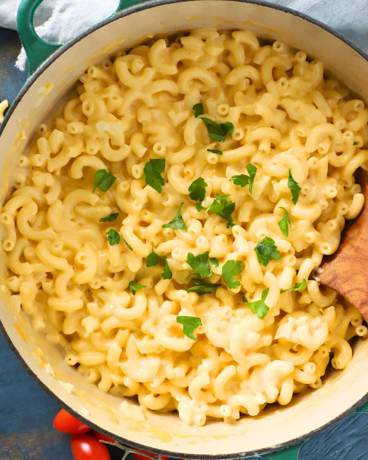 Pot of cauliflower mac and cheese topped with fresh parsely.