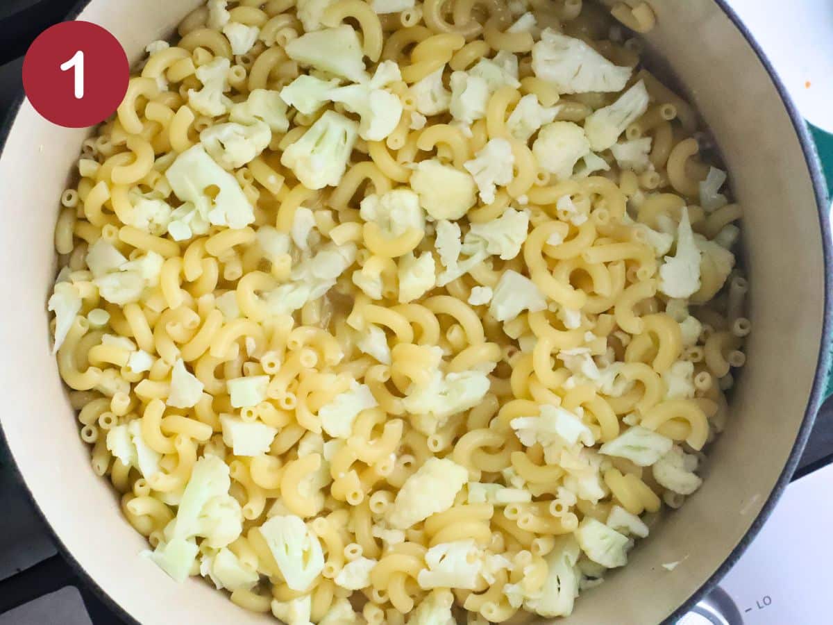 A pot with cauliflower and elbow macaroni.