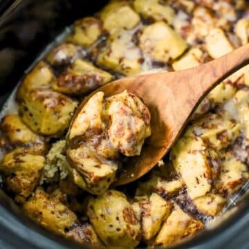 Slow cooker full of cinnamon roll casserole.