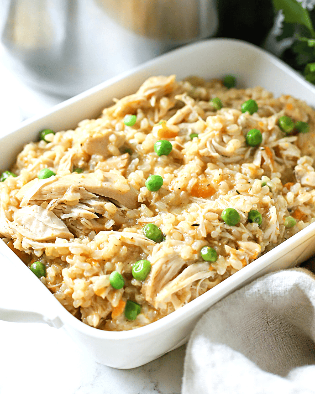 Chicken, rice and veggies in a dish.