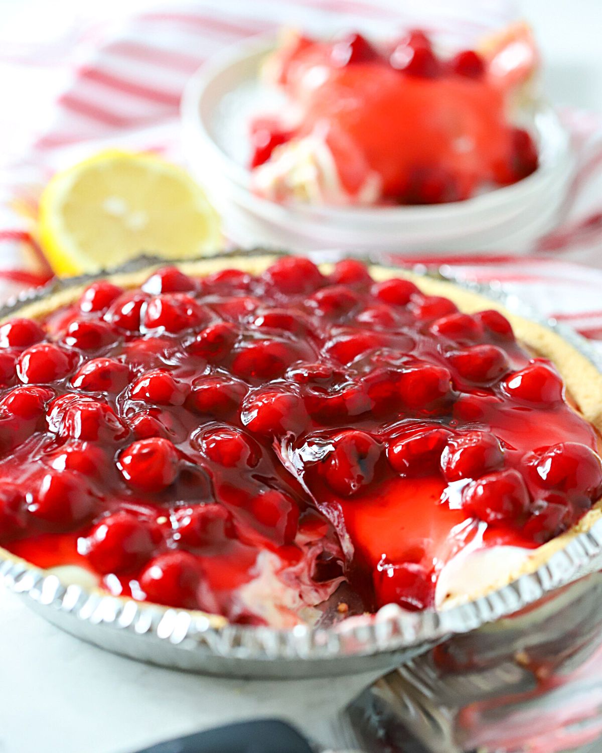 Cherry cheesecake with a slice cut out.