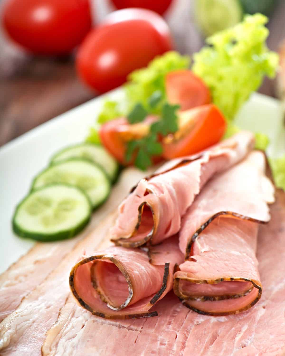 slices of ham on a cutting board.