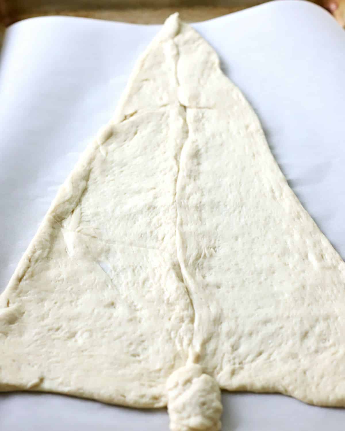 Pizza dough cut to look like a Christmas tree.