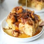 Syrup being poured over breakfast casserole.