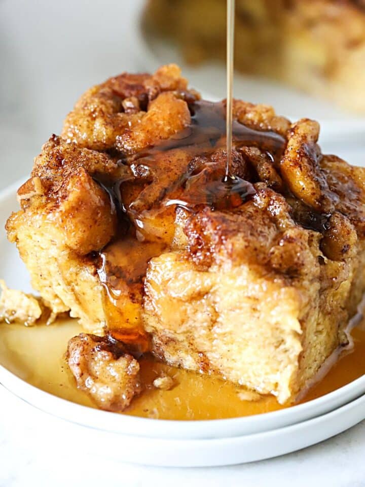 Syrup being poured over breakfast casserole.