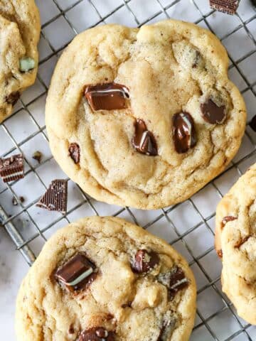 Close up of a mint chocolate cookie on a wire cooling rack.