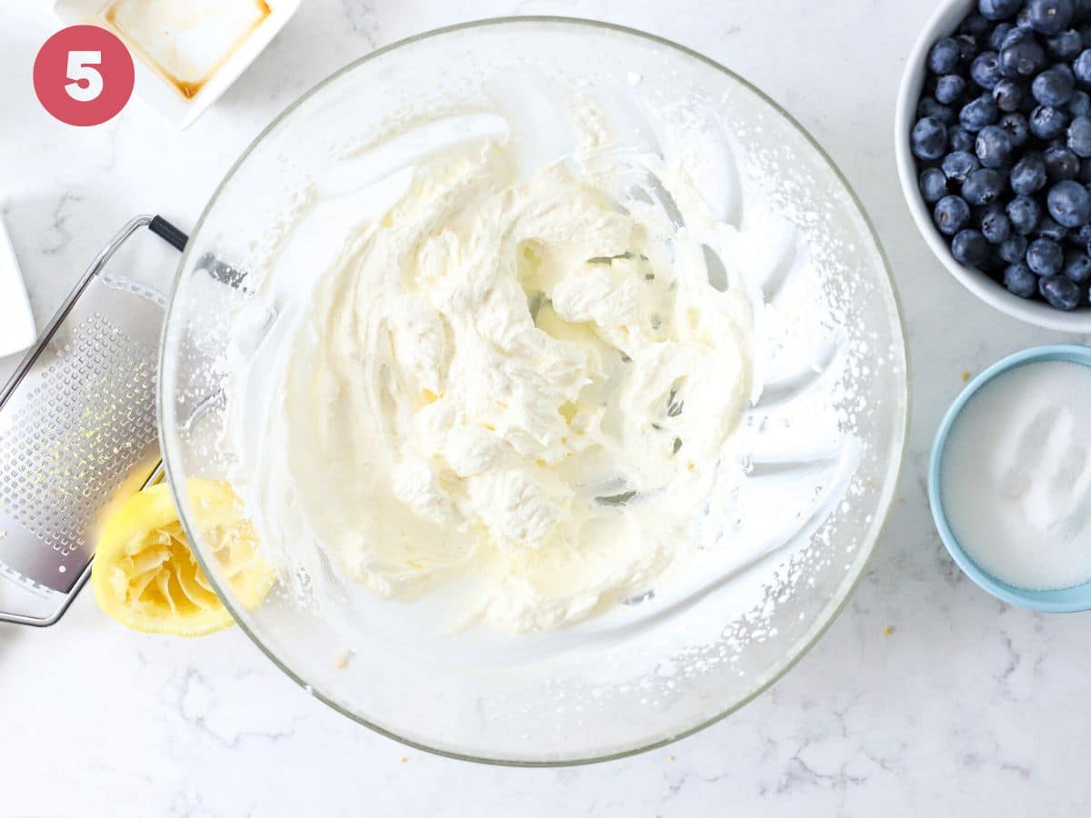 Freshly whipped cream in a mixing bowl.