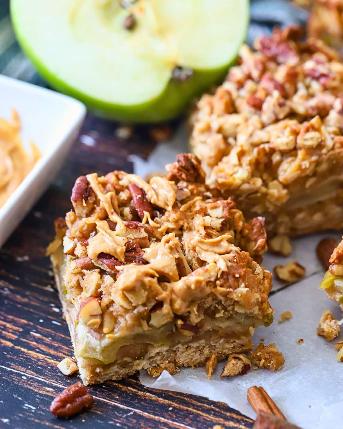 Apple oatmeal bar with peanut butter drizzled on top.