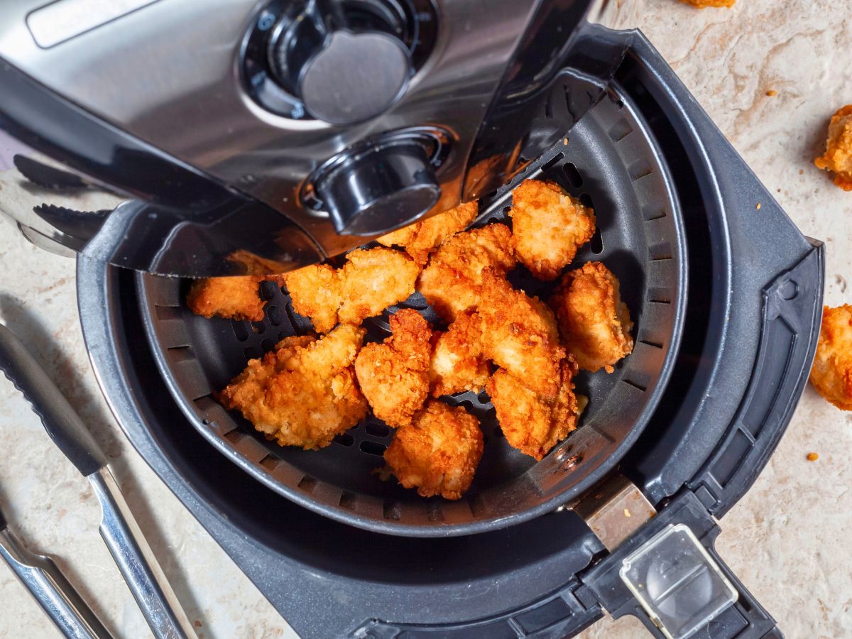 Chicken strips in an air fryer.