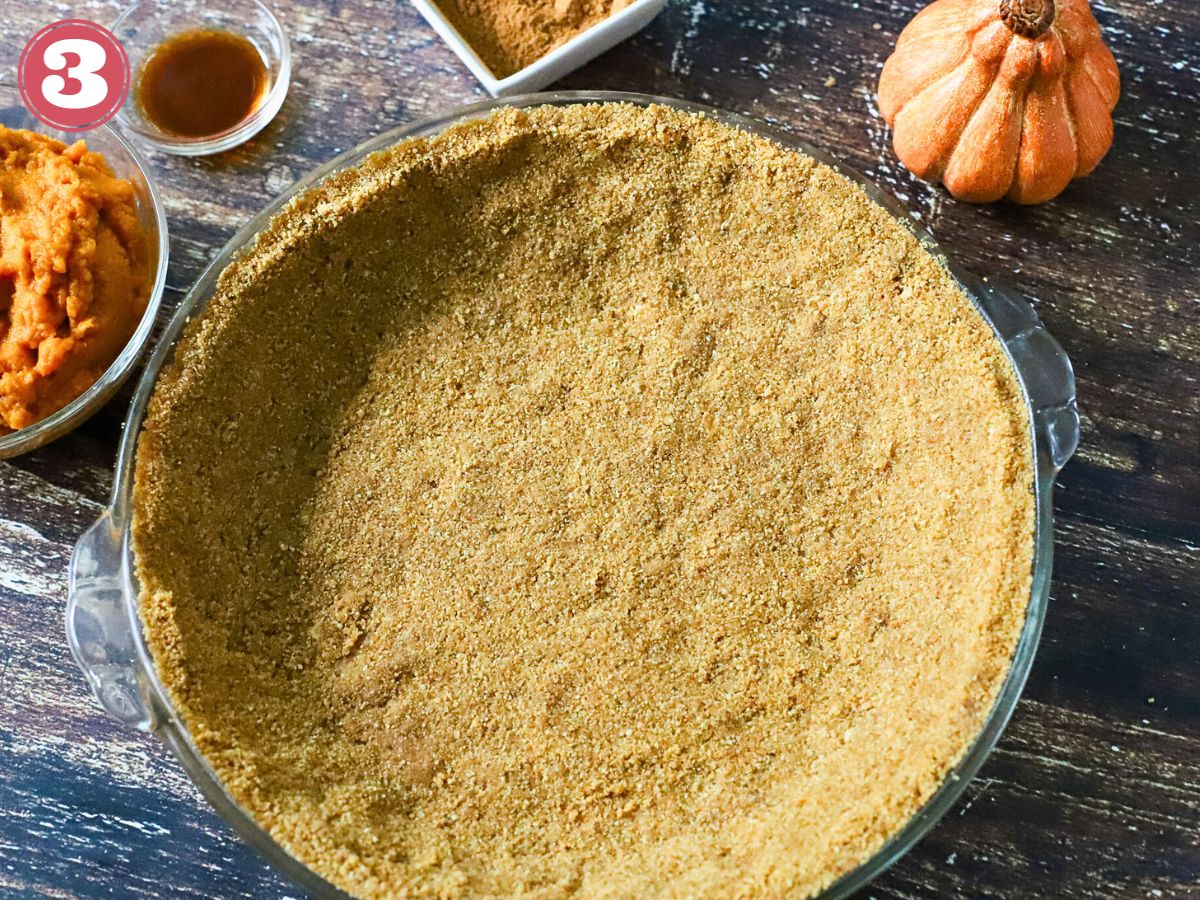 Graham cracker crust in a pie plate.