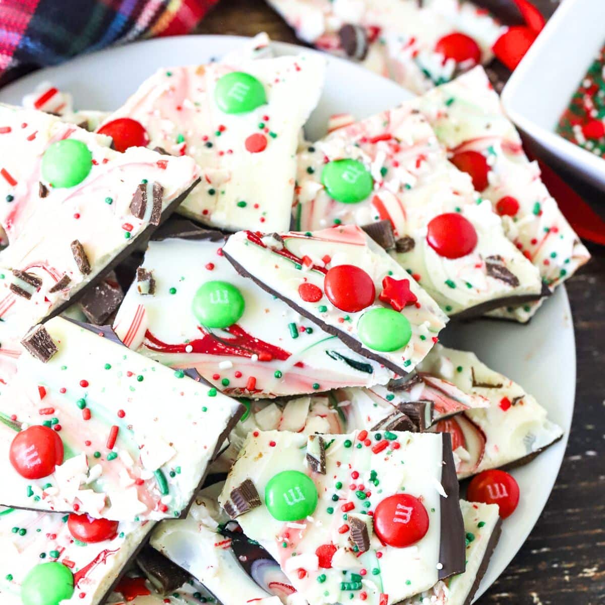 Plate of Christmas Bark with M&Ms and sprinkles.