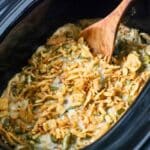 A crock pot green bean casserole freshly cooked.