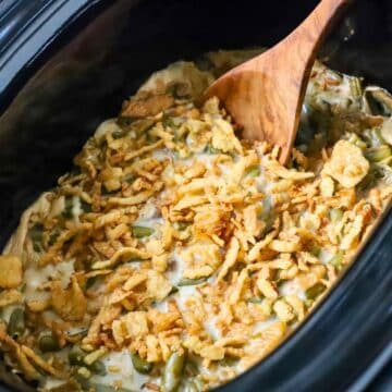 A crock pot green bean casserole freshly cooked.