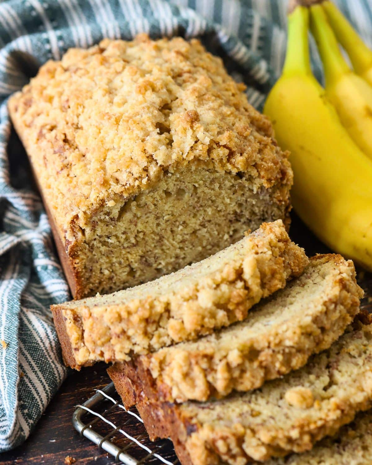 A loaf of banana bread cut into slices for freezing.