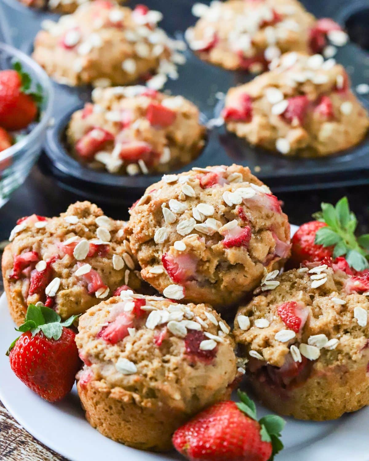 A plate full of healthy strawberry muffins.