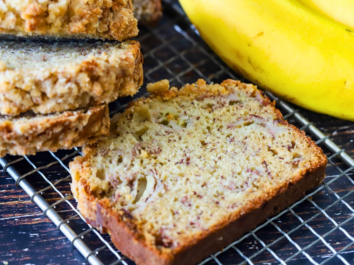 A slice of banana bread on a cooling rack.