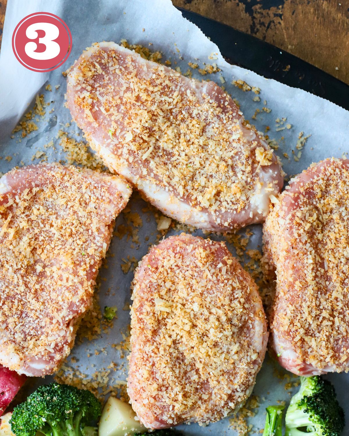 Four pork chops with a Parmesan rub on them.