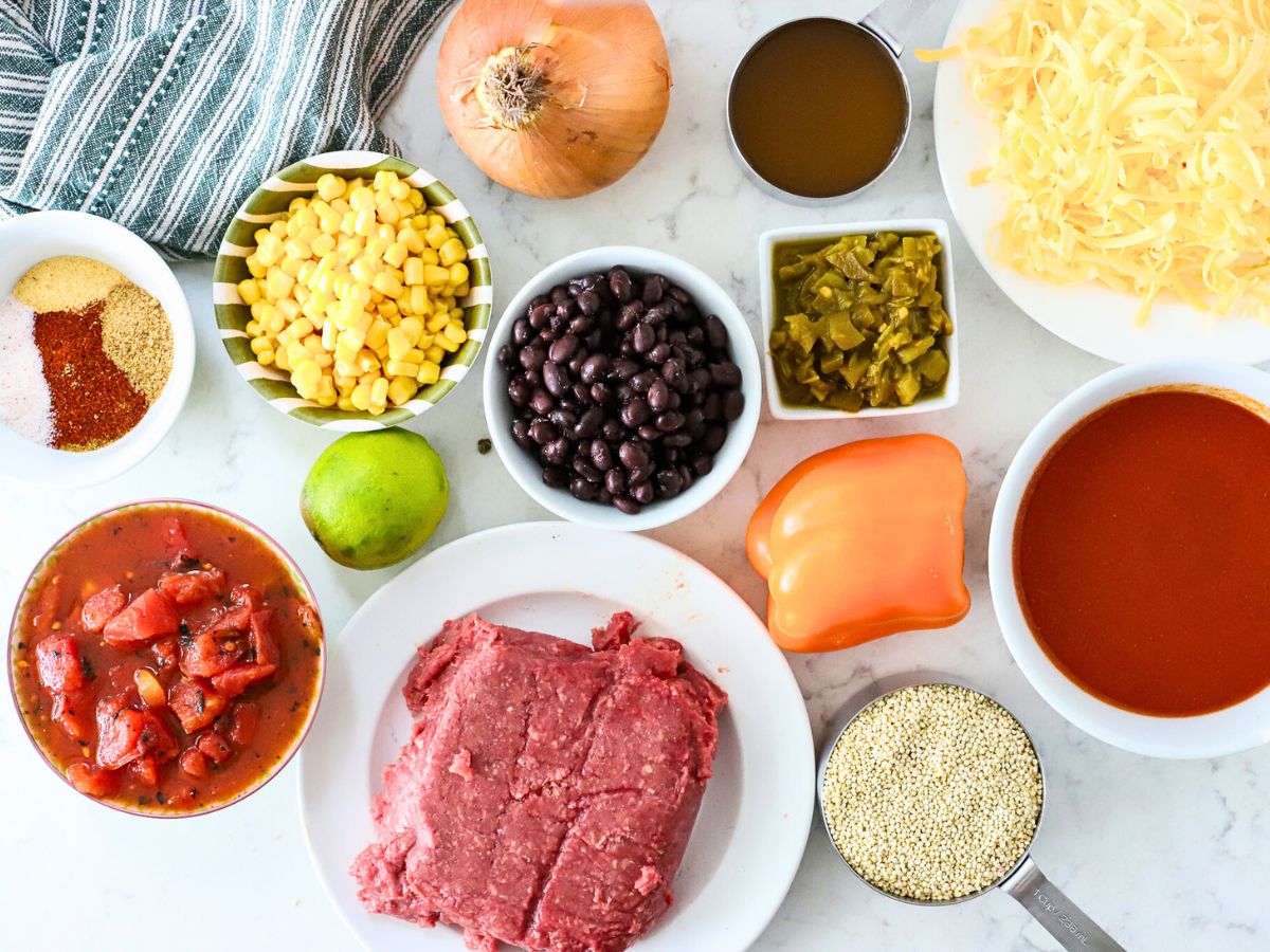 Ingredients to make a slow cooker casserole with ground beef and Mexican spices.