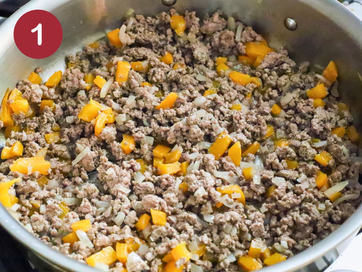 Pan filled with cooked ground beef, onions, and peppers.