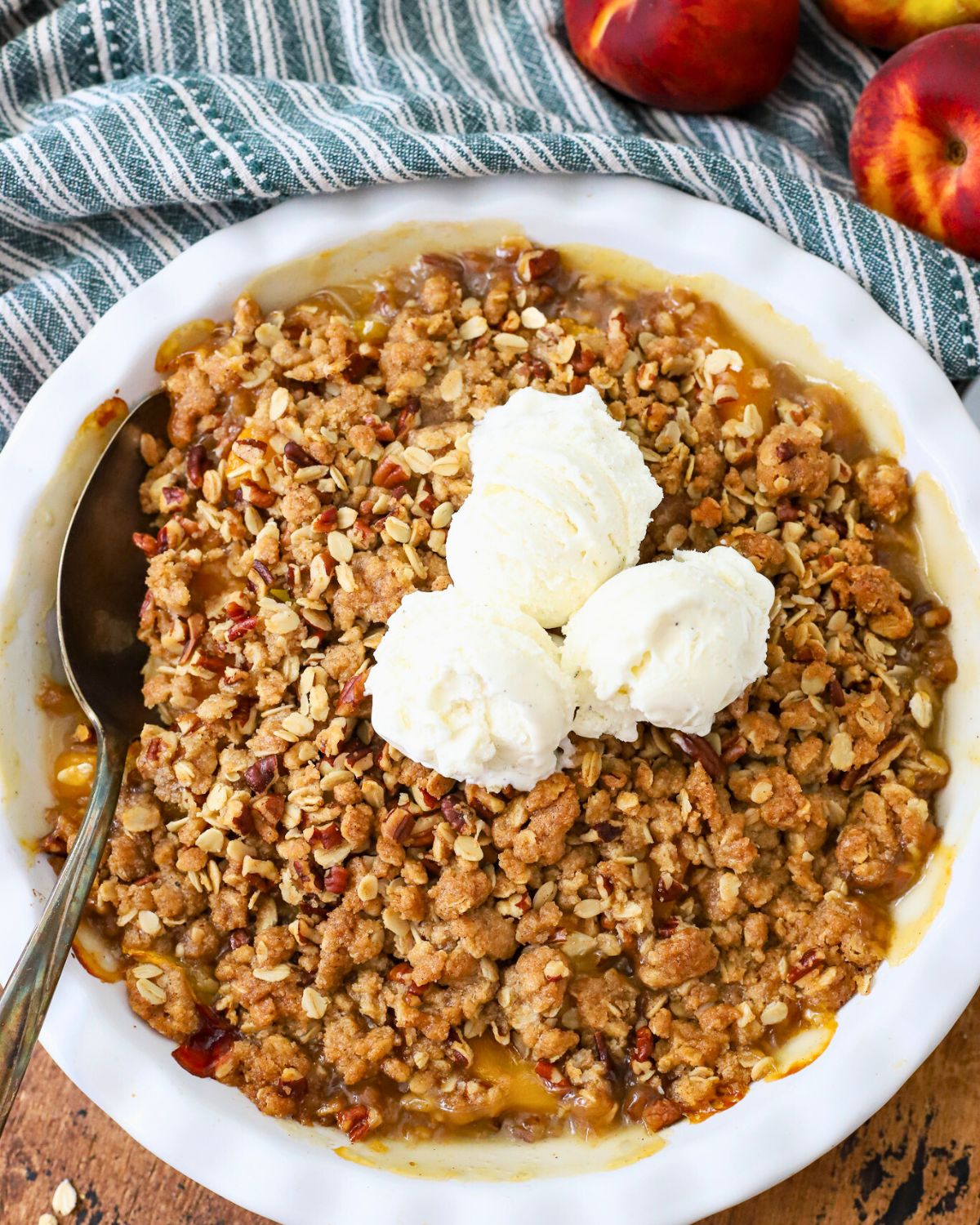 Pie plate filled with fresh baked peach crisp.