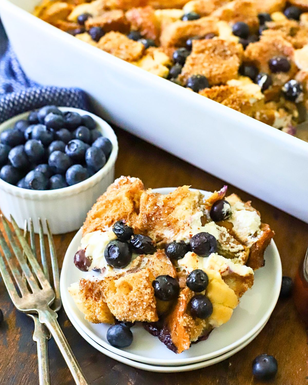 A plate with a serving of blueberry French toast casserole.