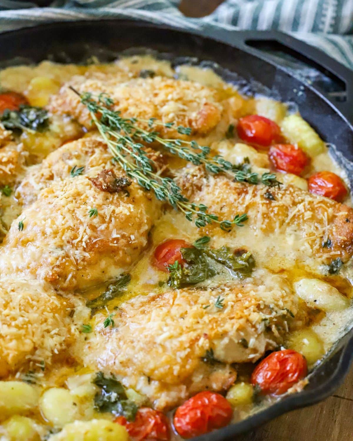 pan filled with chicken, gnocchi, and cream sauce.