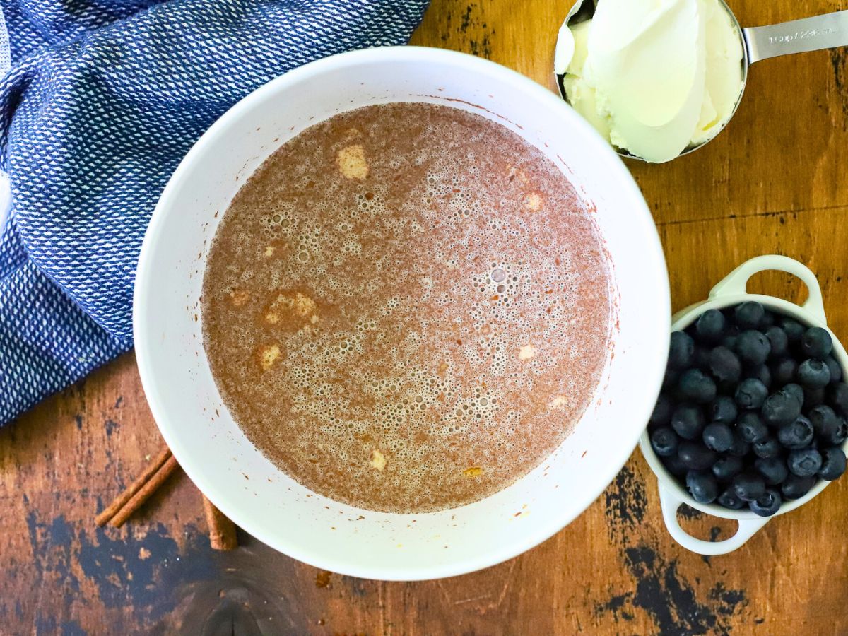 A bowl filled with egg custard for French toast.