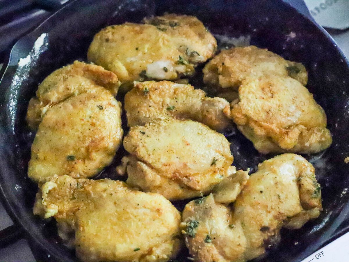 Chicken fried in a cast iron skillet.