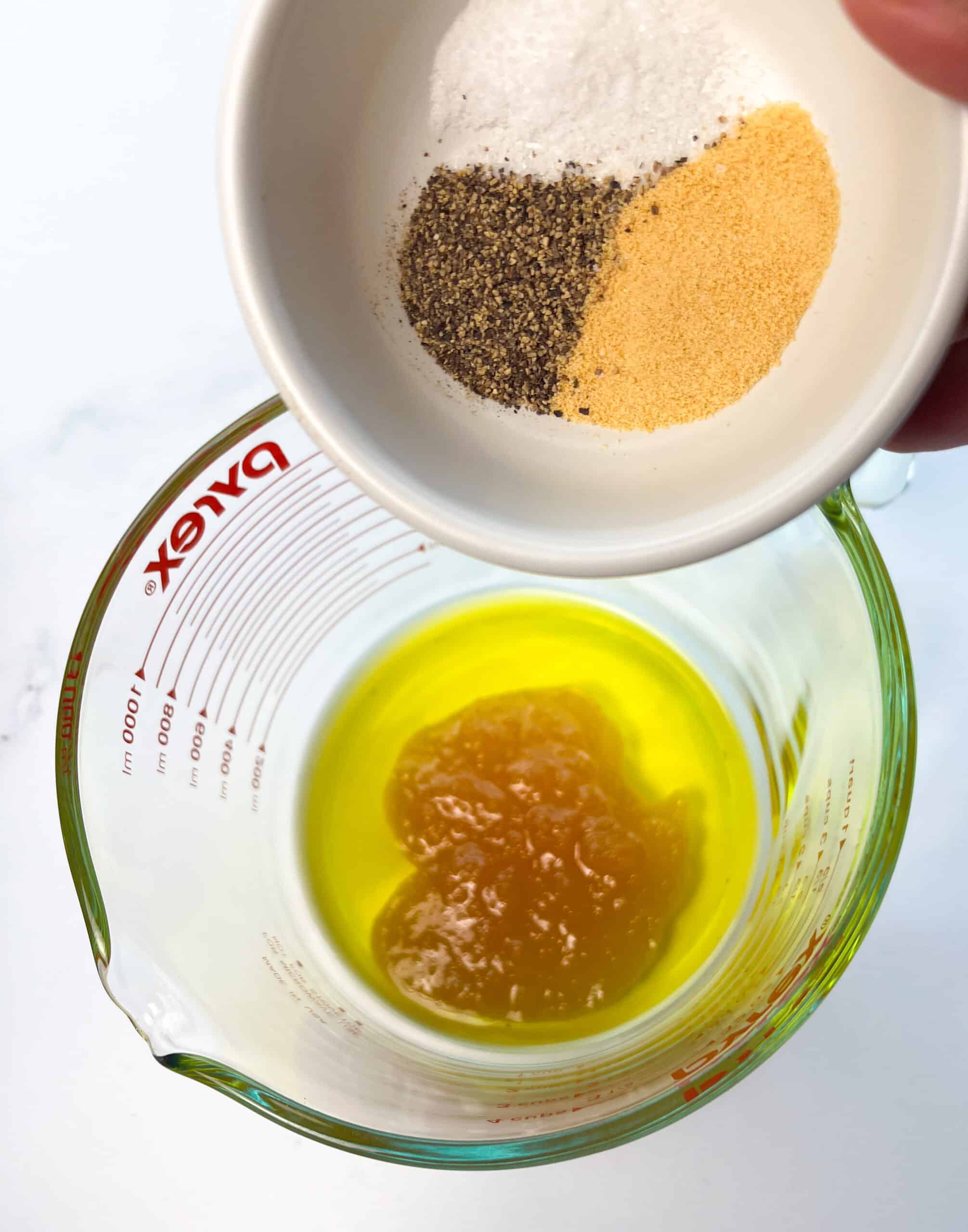 Spices into olive oil and honey mixture