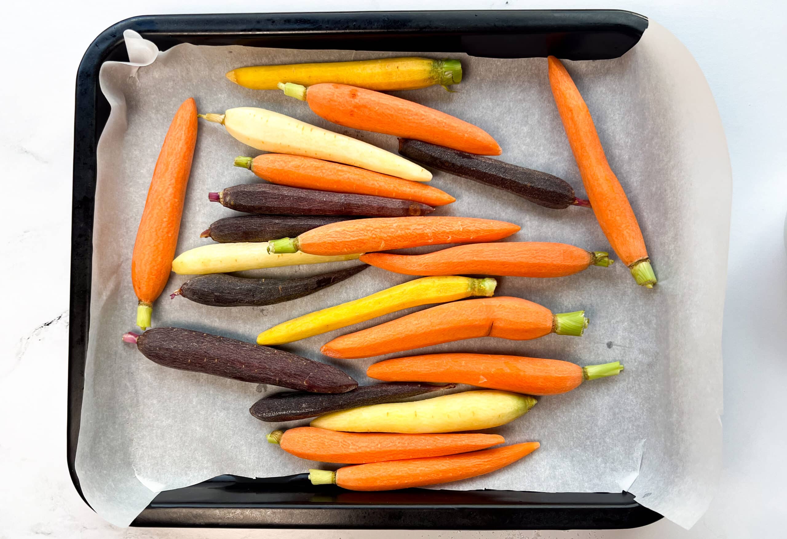 Carrots on a parchment lined baking sheet