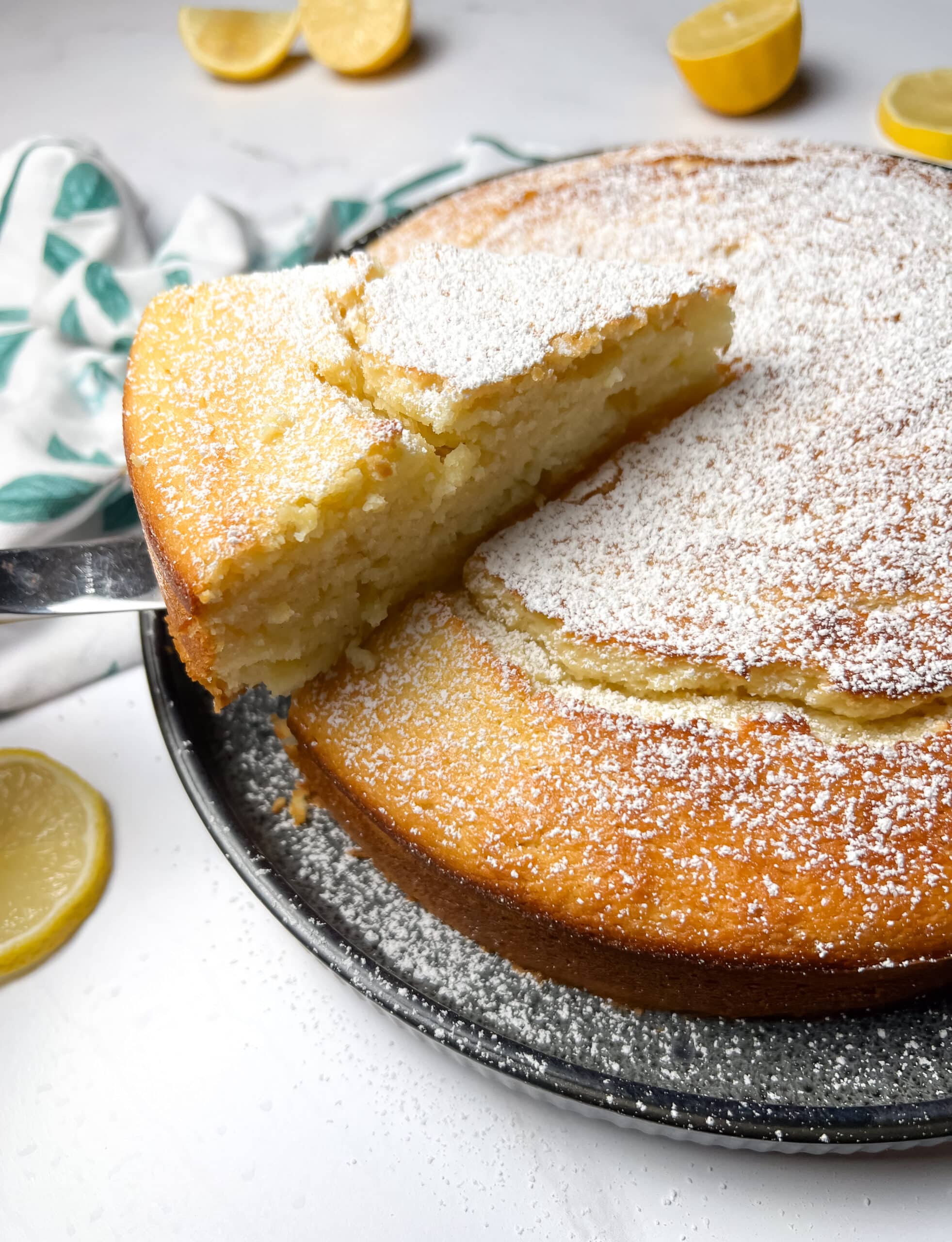 Limoncello ricotta cake with a slice being lifted out