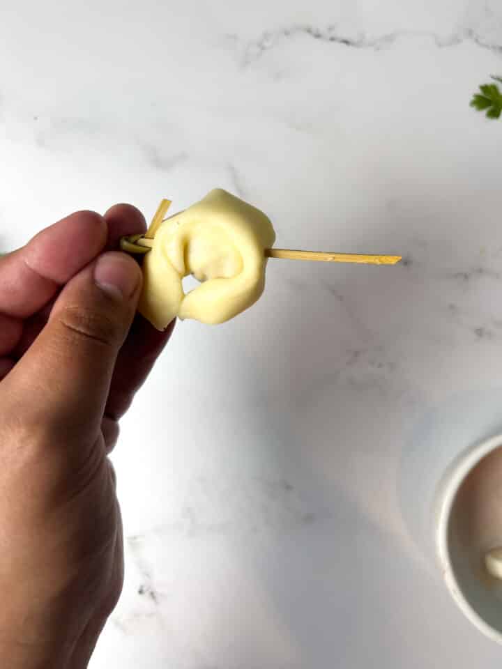 tortellini caprese skewers being assembled