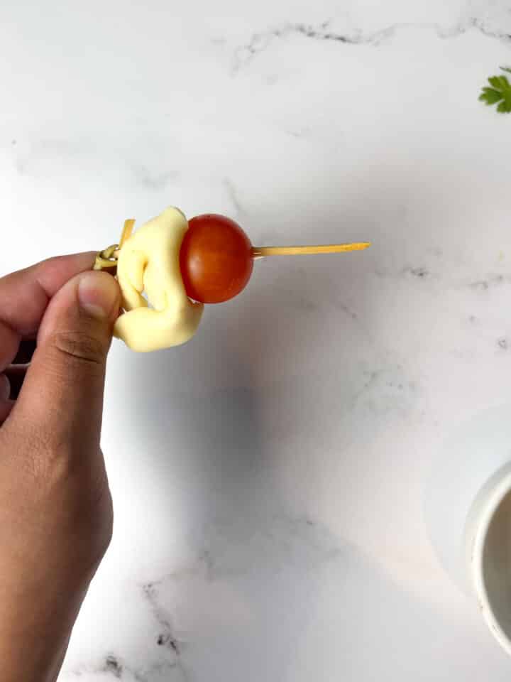 tortellini caprese skewers being assembled