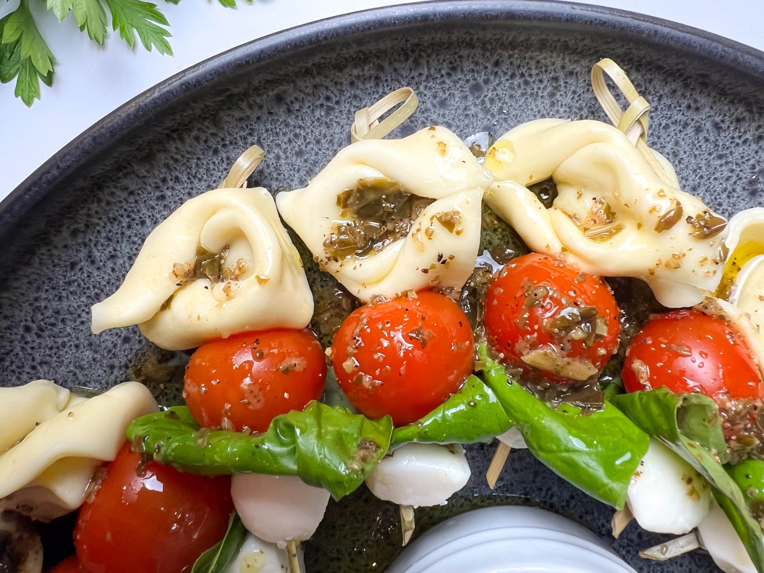 Closeup of finished tortellini caprese skewers