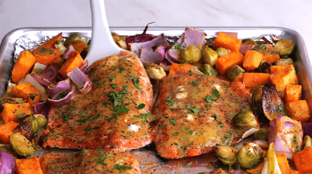 Sheet pan salmon with roasted vegetables on a baking sheet