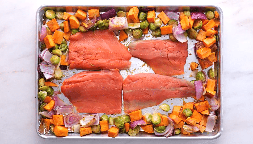 Sheet pan salmon unbaked without seasoning on a baking sheet